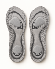 Pair of gray comfort insoles on warm white