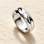 Silver-tone R0241Y wave ring on a light stone surface