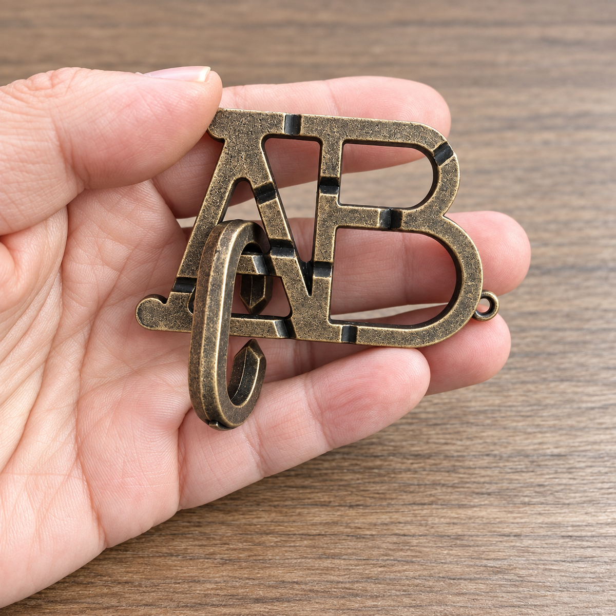 AB Letter Interlocking Metal Puzzle held in hands