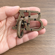 AB Letter Interlocking Metal Puzzle held in hands
