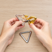 Triangular Interlocking Metal Puzzle held in hands