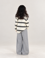 Girls' striped top and gray wide-leg pants, rear view