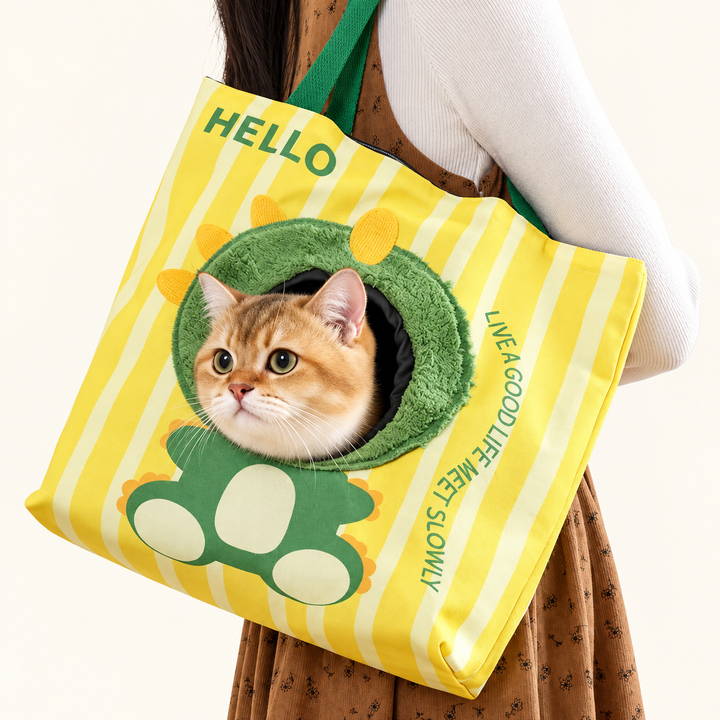 Green dinosaur canvas pet carrier tote worn with a cat inside