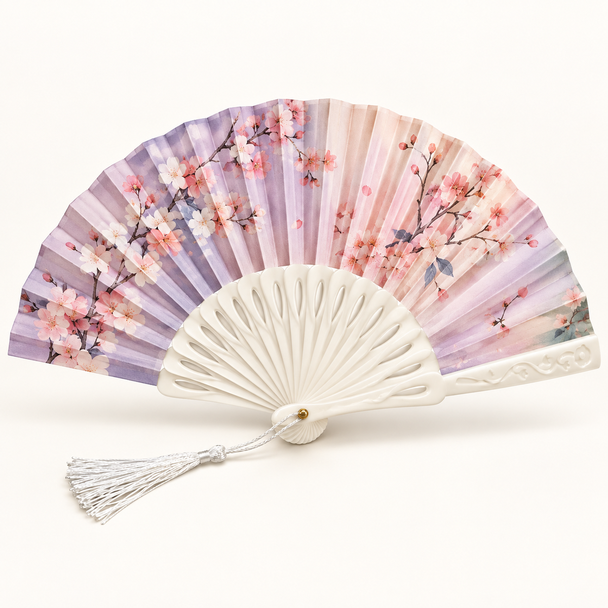 Pastel floral folding hand fan with ivory ribs and white tassel on a white studio background