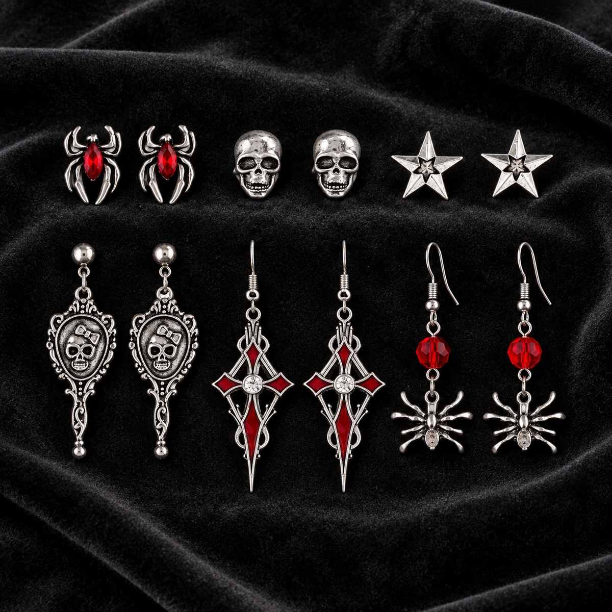 Six pairs of gothic skull spider and crystal earrings