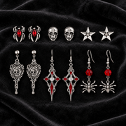 Six pairs of gothic skull spider and crystal earrings