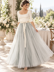 Sage layered tulle maxi skirt with champagne ribbon waist in an elegant setting
