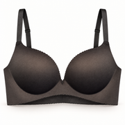 Streamline black nude smoothing wireless bra on a warm-white studio background